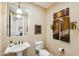 Elegant powder room with pedestal sink and art accents at 29432 N 128Th Ln, Peoria, AZ 85383