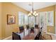 Elegant dining room with a wood table, chandelier, and French doors at 29432 N 128Th Ln, Peoria, AZ 85383