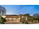 Evening view of home's exterior, showcasing garage and landscaping at 29432 N 128Th Ln, Peoria, AZ 85383