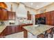 Gourmet kitchen boasts granite countertops and rich wood cabinetry at 29432 N 128Th Ln, Peoria, AZ 85383