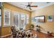 Cozy sitting area in bedroom with two armchairs and a large TV at 29432 N 128Th Ln, Peoria, AZ 85383