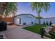 Backyard with artificial turf, wood fence, and a detached garage at 3002 E Mitchell Dr, Phoenix, AZ 85016
