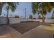 Backyard with gravel, a raised garden bed, and mature trees at 3002 E Mitchell Dr, Phoenix, AZ 85016