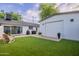 Spacious backyard with artificial turf, patio, and a detached garage at 3002 E Mitchell Dr, Phoenix, AZ 85016
