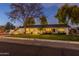 Charming home with well-lit landscaping at dusk at 3002 E Mitchell Dr, Phoenix, AZ 85016