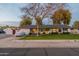 White single story home with manicured lawn and tree at 3002 E Mitchell Dr, Phoenix, AZ 85016