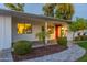 Inviting front porch with red door and landscaping at 3002 E Mitchell Dr, Phoenix, AZ 85016