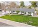 Expansive front yard with mature landscaping and charming curb appeal at 3002 E Mitchell Dr, Phoenix, AZ 85016