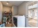 Laundry room with washer, dryer, and storage shelves at 3002 E Mitchell Dr, Phoenix, AZ 85016