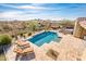 Stunning aerial view of a refreshing pool, expansive patio, and mountain backdrop at 32807 N 15Th Gln, Phoenix, AZ 85085