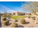 Landscaped backyard with grassy area and mature trees at 32807 N 15Th Gln, Phoenix, AZ 85085