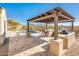 Desert landscape with a sparkling pool, pergola, and built-in BBQ at 32807 N 15Th Gln, Phoenix, AZ 85085