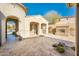 Outdoor patio with fireplace, string lights and stone flooring at 32807 N 15Th Gln, Phoenix, AZ 85085