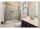 Bathroom with a shower/tub combo and dark vanity at 32807 N 15Th Gln, Phoenix, AZ 85085