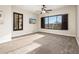 Spacious bedroom with carpeted floors, large window, and ceiling fan at 32807 N 15Th Gln, Phoenix, AZ 85085