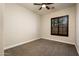 Well-lit bedroom featuring carpeted floors and window with shutters at 32807 N 15Th Gln, Phoenix, AZ 85085