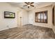 Bright bedroom with wood-look floors, ceiling fan, and private access at 32807 N 15Th Gln, Phoenix, AZ 85085