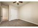 Bright bedroom with carpet, double doors, and access to hallway at 32807 N 15Th Gln, Phoenix, AZ 85085