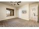 Bedroom with carpet, window, ceiling fan, and access to hallway at 32807 N 15Th Gln, Phoenix, AZ 85085