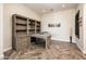 Bright home office with L-shaped desk and ample built-in shelving at 32807 N 15Th Gln, Phoenix, AZ 85085