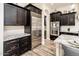 Modern kitchen with dark cabinetry and stainless steel appliances at 32807 N 15Th Gln, Phoenix, AZ 85085