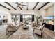 Living room features hardwood floors, exposed wood beams, and a large TV at 32807 N 15Th Gln, Phoenix, AZ 85085