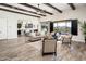 Spacious living room with wood beams, a view of the pool and mountains, and hardwood floors at 32807 N 15Th Gln, Phoenix, AZ 85085