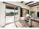 Living area with sliding glass doors leading to a pool and patio at 32807 N 15Th Gln, Phoenix, AZ 85085