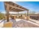 Covered patio with outdoor kitchen and seating area at 32807 N 15Th Gln, Phoenix, AZ 85085