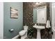 Elegant powder room with pedestal sink and decorative tile at 32807 N 15Th Gln, Phoenix, AZ 85085