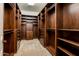 Large walk-in closet with ample shelving and drawers at 32807 N 15Th Gln, Phoenix, AZ 85085