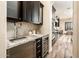 Modern wet bar with wine cooler and granite countertops at 32807 N 15Th Gln, Phoenix, AZ 85085