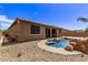 Home exterior showcasing a sparkling pool and rock waterfall feature at 35134 N Laredo Dr, San Tan Valley, AZ 85144