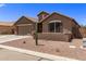 House with a two-car garage, cactus, and desert landscaping at 35134 N Laredo Dr, San Tan Valley, AZ 85144