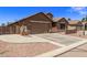 Tan house with a two-car garage and a gravel driveway at 35134 N Laredo Dr, San Tan Valley, AZ 85144