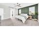 Main bedroom with plush carpeting, a ceiling fan, and an accent wall at 37762 N Poplar Rd, San Tan Valley, AZ 85140