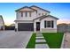 Two-story home with modern facade, dark garage door, and landscaped lawn at 37762 N Poplar Rd, San Tan Valley, AZ 85140