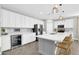 Spacious kitchen with white cabinetry, island, and modern appliances at 37762 N Poplar Rd, San Tan Valley, AZ 85140