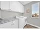 Laundry room with white cabinets and marble countertops at 37762 N Poplar Rd, San Tan Valley, AZ 85140