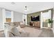 Cozy living room features a neutral color palette, large TV, and comfortable seating at 37762 N Poplar Rd, San Tan Valley, AZ 85140