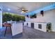 Modern outdoor kitchen with grill, sink, and bar seating at 37762 N Poplar Rd, San Tan Valley, AZ 85140