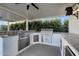 Stainless steel appliances and granite countertops in this outdoor kitchen at 37762 N Poplar Rd, San Tan Valley, AZ 85140