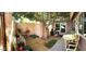 Enclosed backyard with mature tree, patio seating, a vintage bicycle and pet resting area at 4043 E Arbor Ave, Mesa, AZ 85206