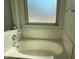 Relaxing bathroom with an oval bathtub and window at 4043 E Arbor Ave, Mesa, AZ 85206