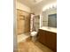 Well-lit bathroom with a shower, storage cabinet, and wood vanity at 4043 E Arbor Ave, Mesa, AZ 85206