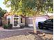 Charming single-story home with stucco facade, arched windows, red tile roof and mature landscaping at 4043 E Arbor Ave, Mesa, AZ 85206