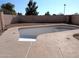 Empty kidney-shaped pool in need of renovation at 4043 E Arbor Ave, Mesa, AZ 85206