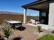 Inviting covered outdoor patio featuring a dining table and lounge seating, perfect for entertaining and enjoying the outdoors at 42223 N Golden Trl, San Tan Valley, AZ 85140