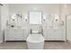 Elegant bathroom with double vanities, free-standing tub, and large mirrors at 42223 N Golden Trl, San Tan Valley, AZ 85140