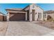 Modern home exterior showcasing a brown garage door and a brick driveway at 42223 N Golden Trl, San Tan Valley, AZ 85140